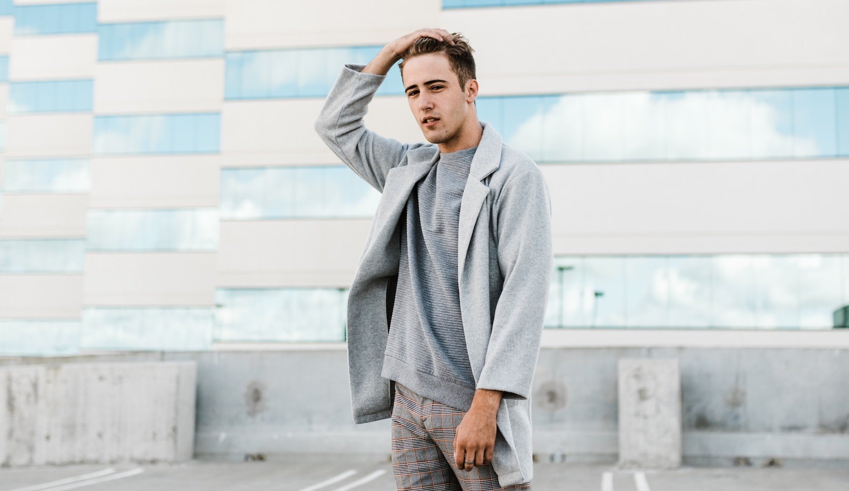 Man Scratching Scalp on Rooftop