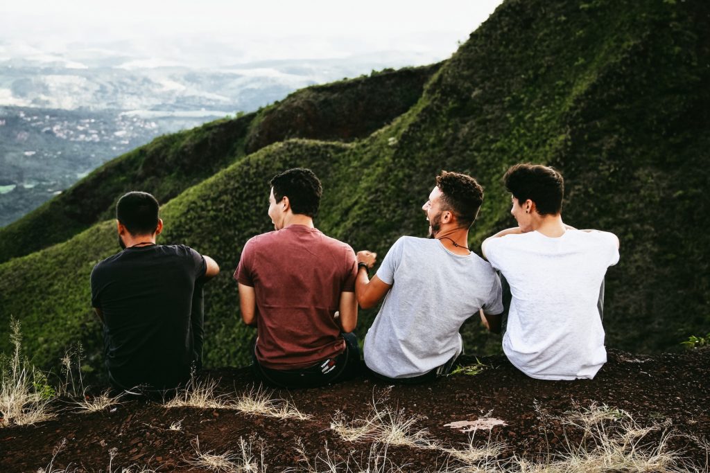 Group of Men Sitting on Hill