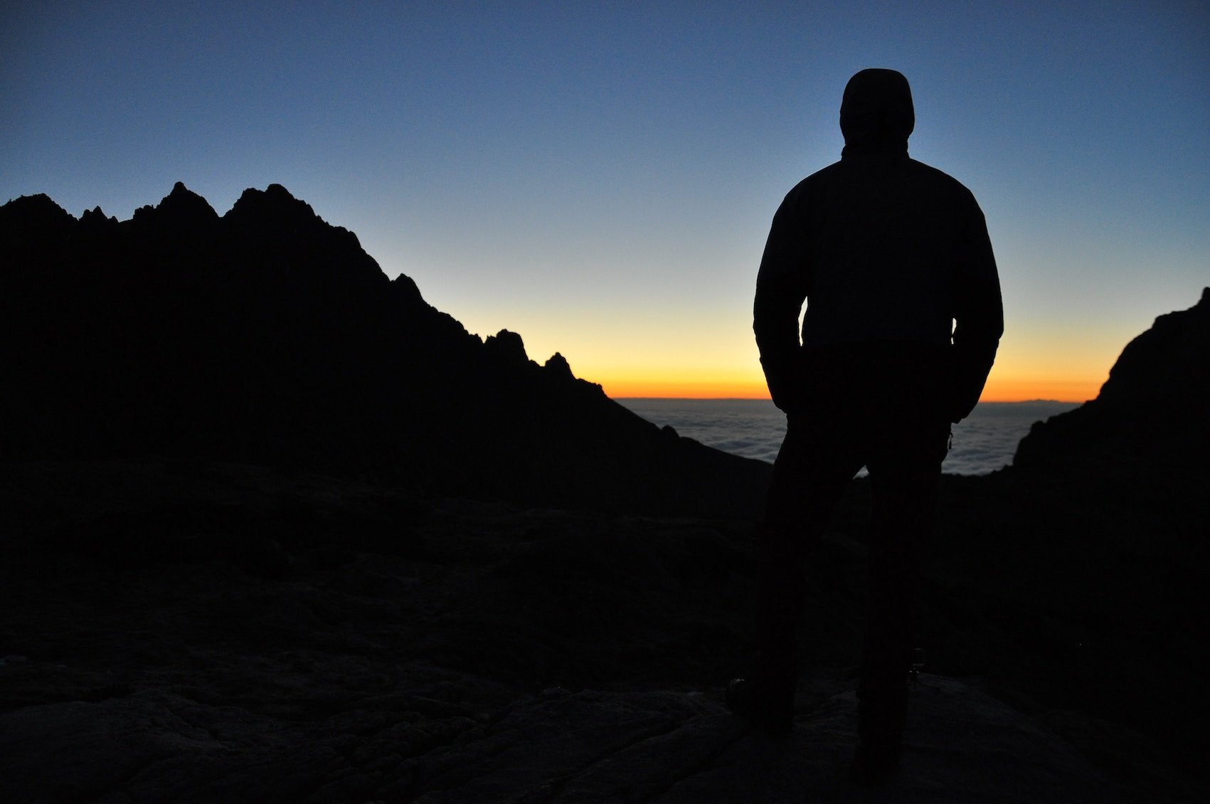 Man overlooking Ocean on Mountains