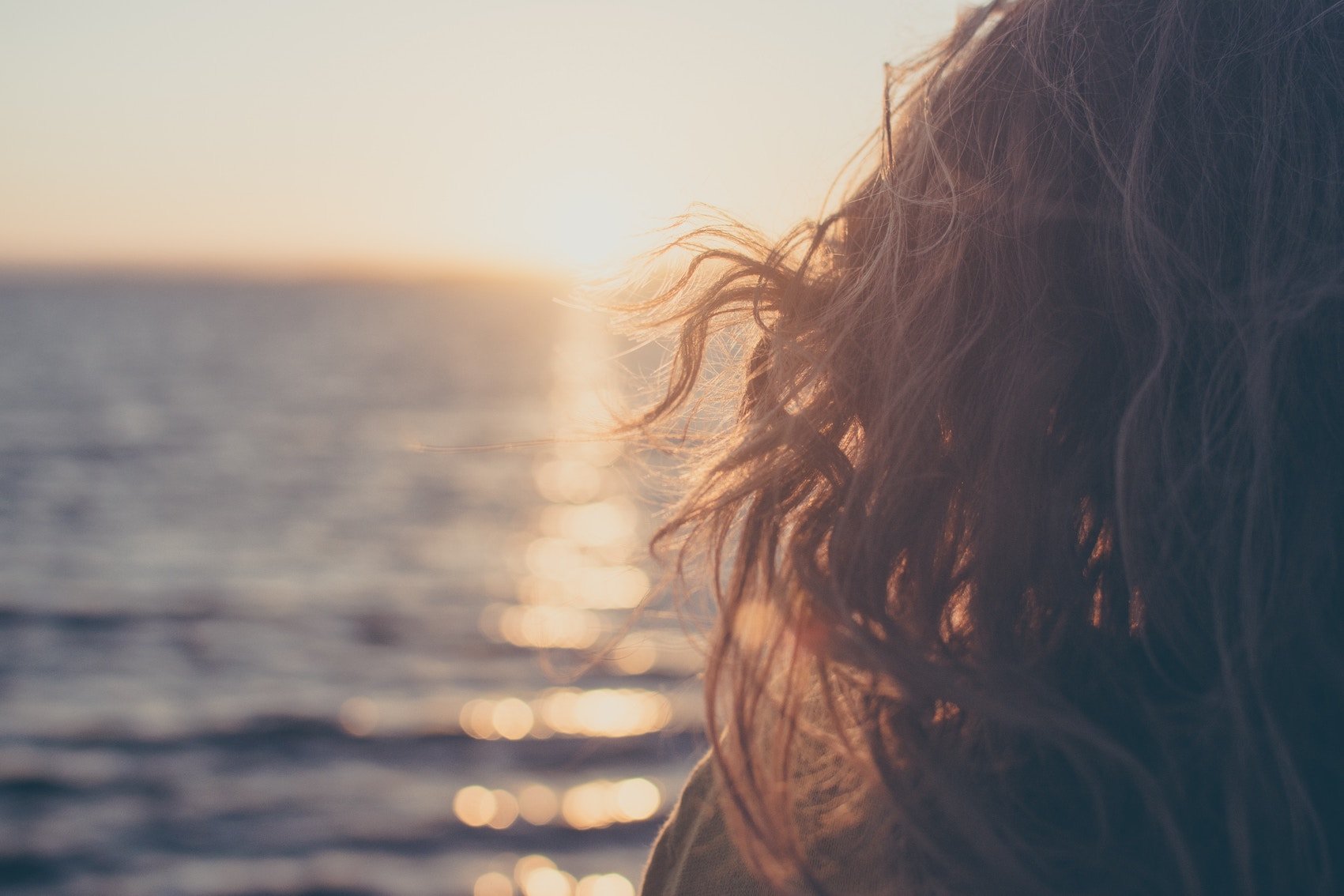 Girl Over looking Ocean at Sunset