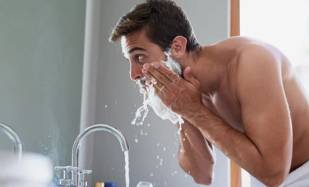 man washing beard